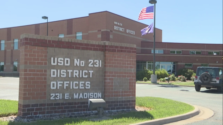 School sign reads: USD No 231 DISTRICT OFFICES 231 E. MADISON