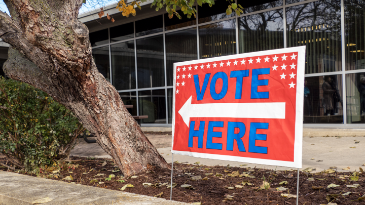 A “vote here” sign is displayed Oct. 25, 2022, at the Shawnee County Election Office in Topeka. (Sherman Smith/Kansas Reflector)