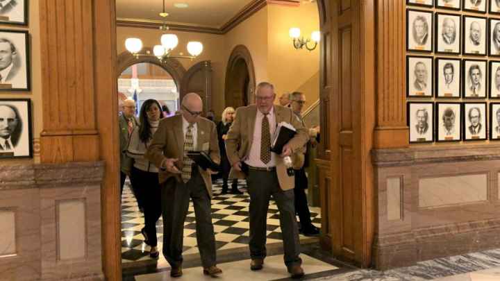 Lawmakers leave the Kansas House chamber after voting to override the governor's veto of the redistricting plan. Blaise Mesa / Kansas News Service