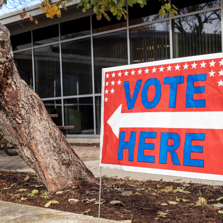 A “vote here” sign is displayed Oct. 25, 2022, at the Shawnee County Election Office in Topeka. (Sherman Smith/Kansas Reflector)
