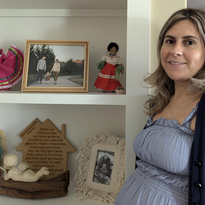Lawrence Brooks IV / KCUR 89.3 Cindy Phillips stands by a shelf filled with family photos and Mexican-themed dolls she brings back to Kearney, Missouri, when she travels back to Mexico. "Its a daily reminder of my heritage for me and my daughter."