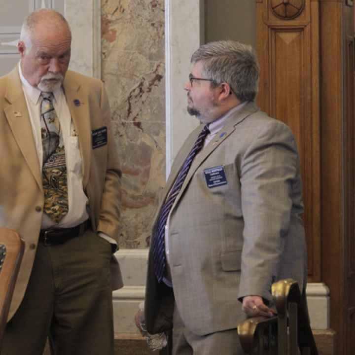  Kansas state Reps. Michael Murphy (left) (R-Sylvia) and Kyle Hoffman (right) (R-Coldwater) confer during a House debate on overriding Democratic Gov. Laura Kelly's veto of a transgender bathroom bill, Thursday, April 27, 2023. | John Hanna/AP Photo